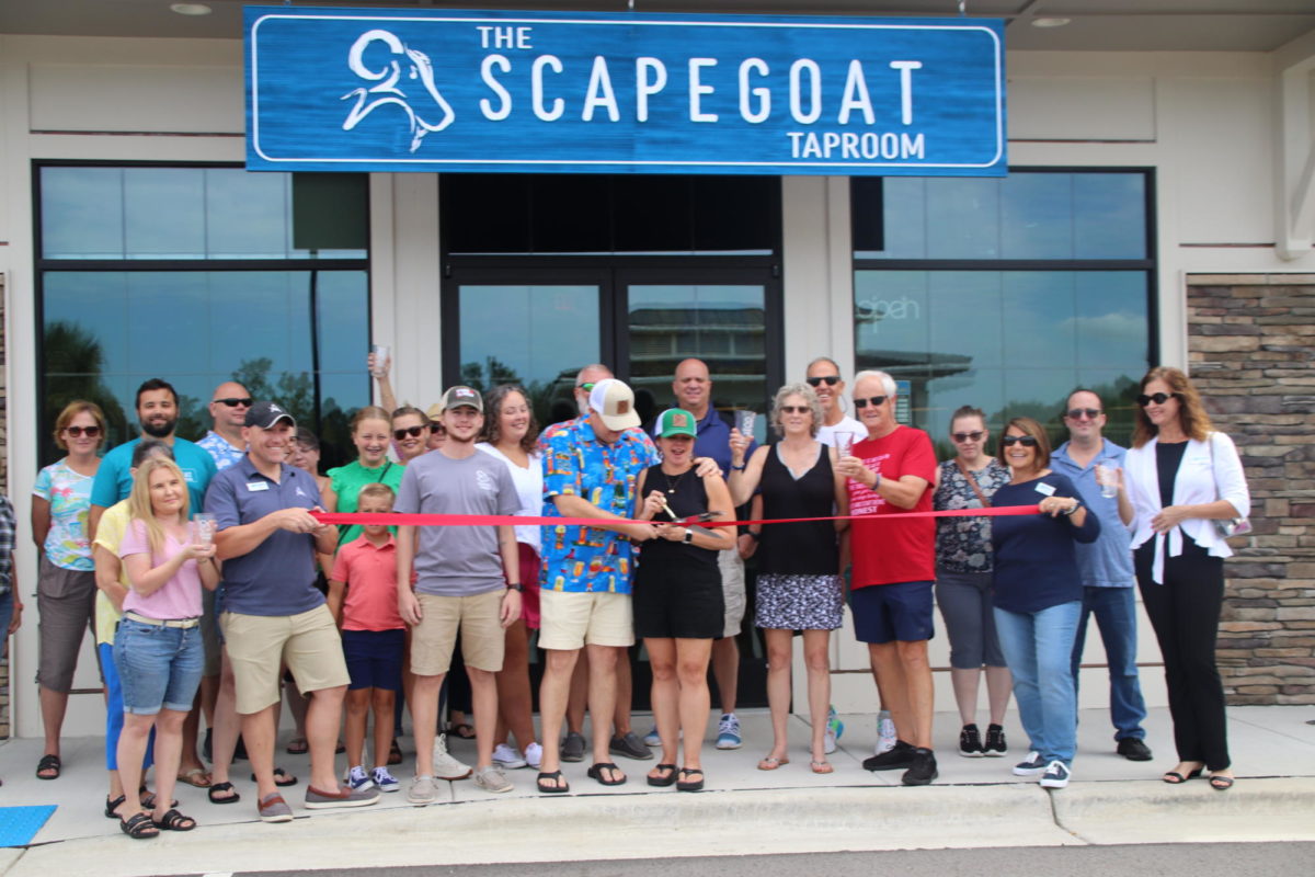 Chris+and+Jody+Walker+cut+the+red+ribbon+for+their+grand+opening+of+The+Scapegoat+Taproom+in+Leland