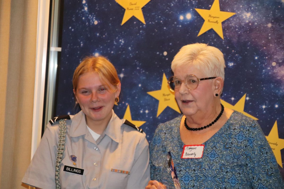 Isabella Billings accepts her trophy  in the category of Middle School Poetry, from Maryann Nunnally.  