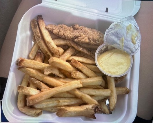 A Chicken Tender Tray from Cookout with Fries and Honey Mustard