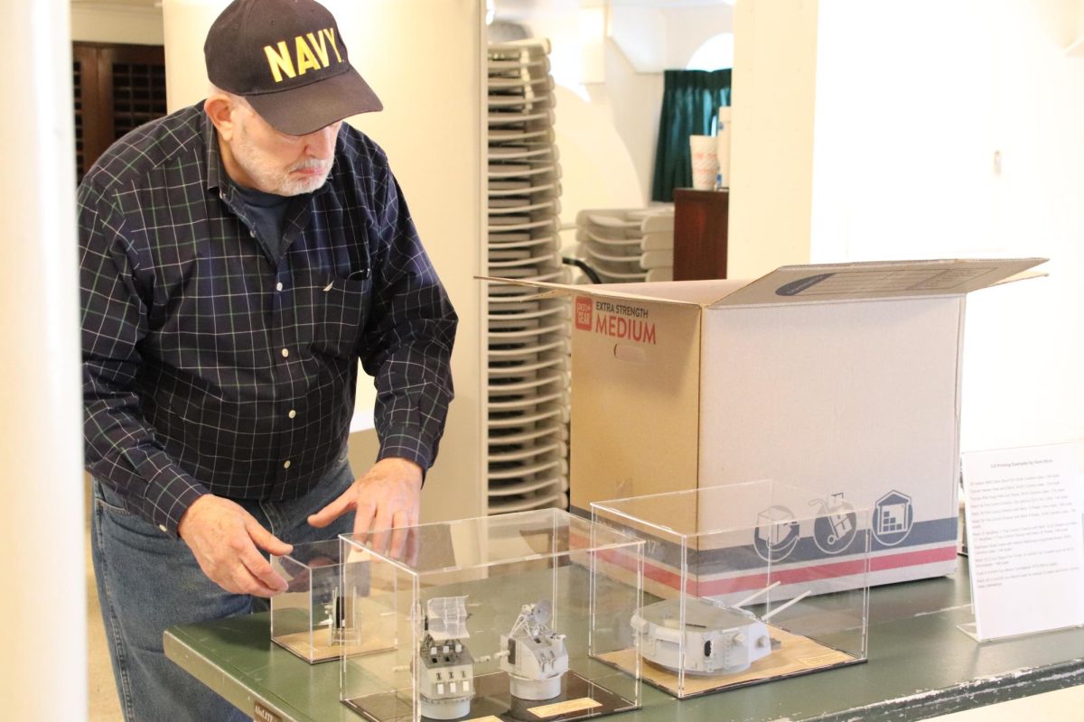 Hank Strub  looks over his 3D image display for the "The Fleet Is In" event on the USS North Carolina, October 19 and 20