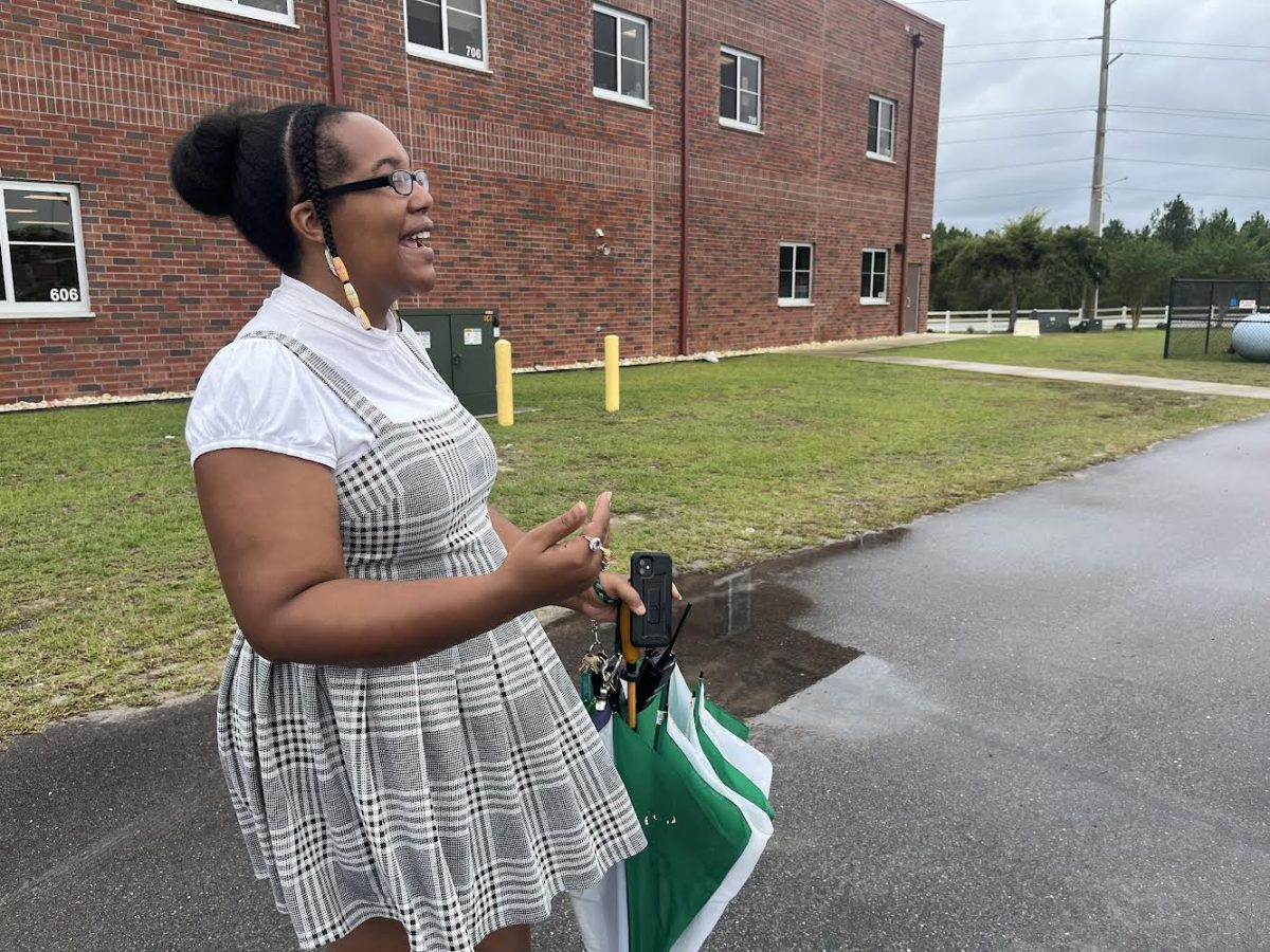 Assistant principal Karla Stanley monitoring students getting on the bus.